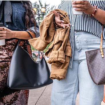 Two women holding clothes